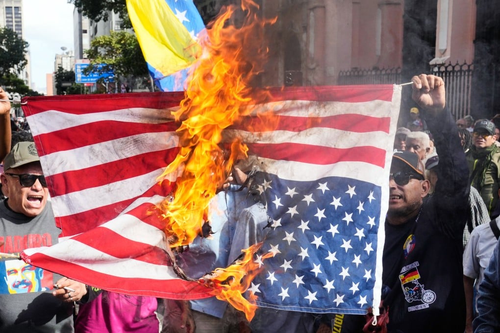 Government supporters burn a US flag in Caracas, Venezuela, on Saturday. Photo: AP