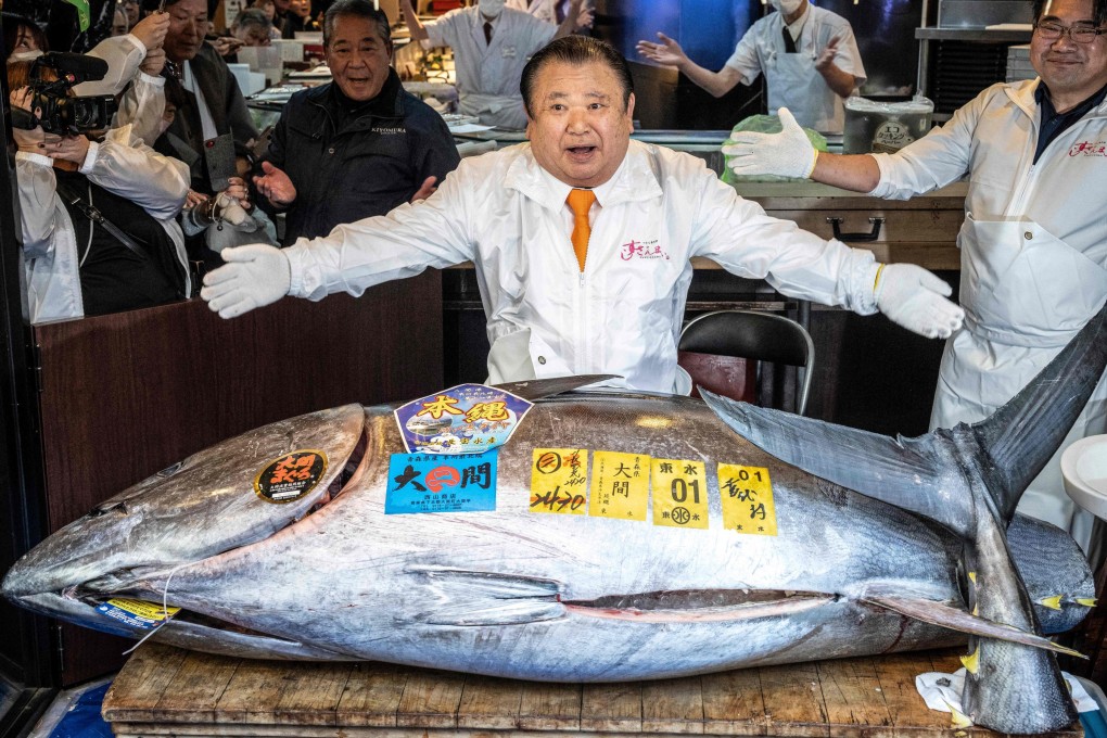 Kiyoshi Kimura displays the 243kg bluefin tuna he bought at his main restaurant in Tokyo on Monday. Photo: AFP
