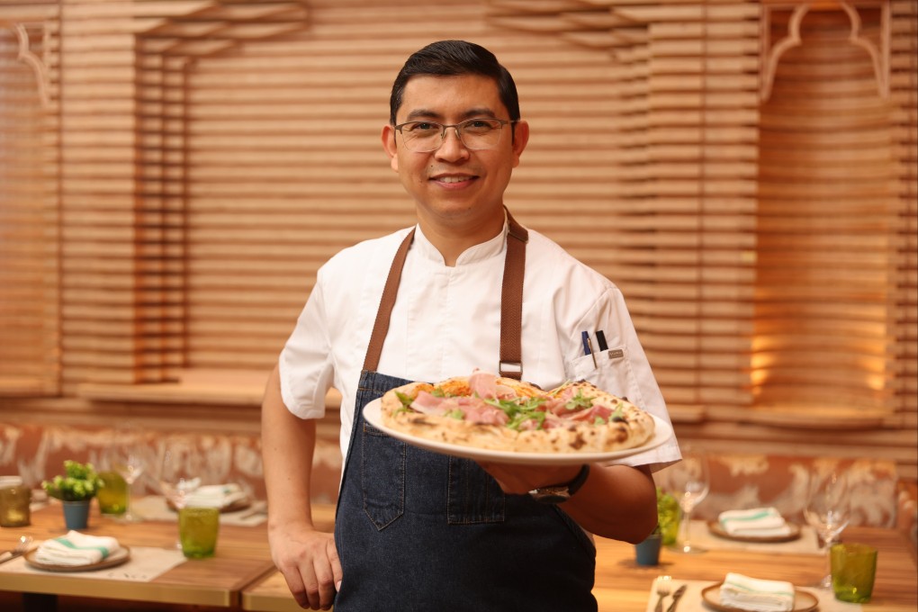 Osteria Uno head chef Bhupendra Singh presents a pizza at the restaurant in Tai Kok Tsui, Hong Kong. Photo: Edmond So