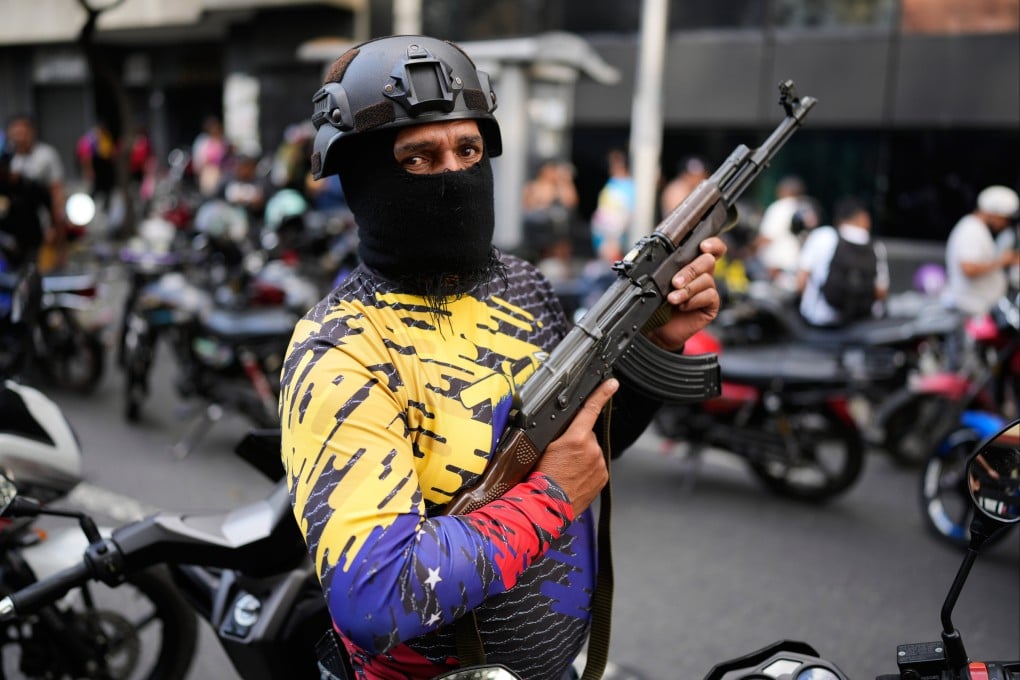 A pro-government, armed civilian in Caracas, Venezuela, attends a protest demanding the release of President Nicolas Maduro and first lady Cilia Flores, after US forces captured and flew them to the United States. Photo: AP