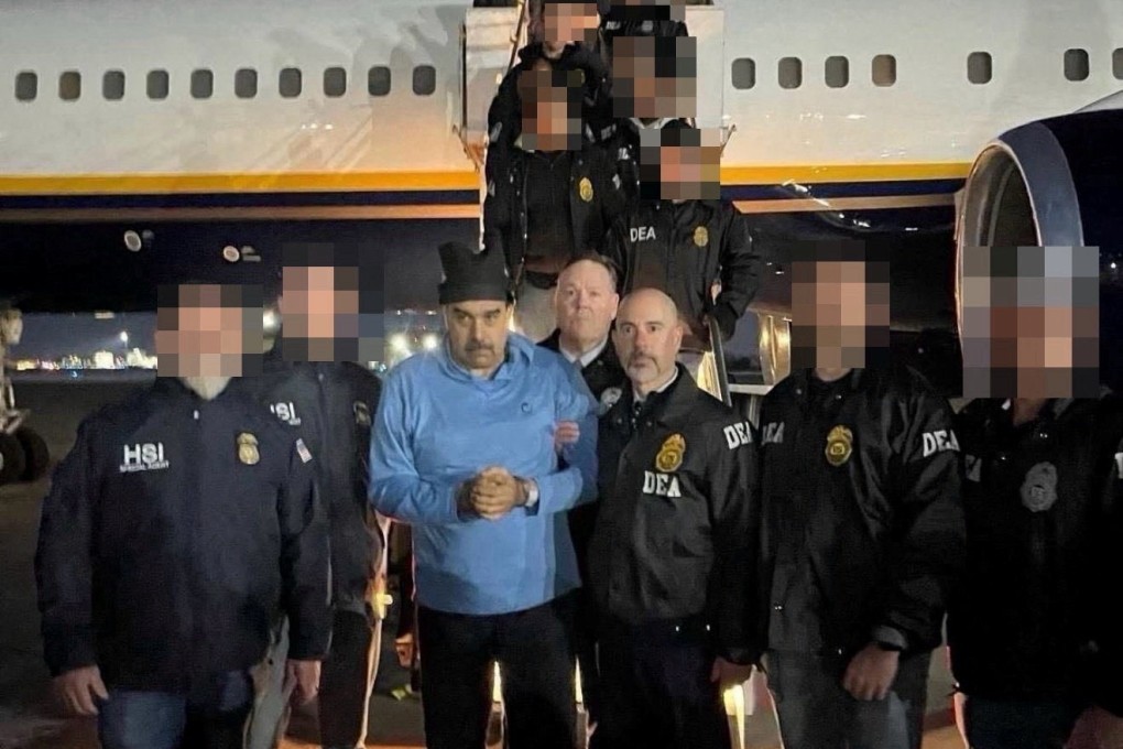 Venezuela’s captured President Nicolas Maduro poses next to US Drug Enforcement Administration (DEA) administrator Terry Cole as he is led in custody from a US federal airplane, at Stewart Air National Guard Base in Newburgh, New York, on January 3, 2026. Photo: Handout via Reuters