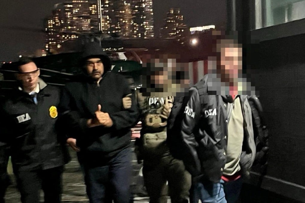 Venezuela’s captured President Nicolas Maduro is led by US Drug Enforcement Administration agents after arriving at a heliport in New York City on Saturday. Photo: Handout via Reuters