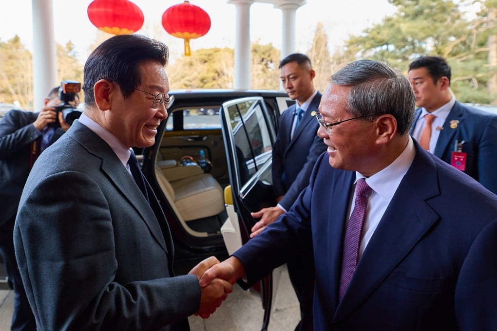 South Korean President Lee Jae Myung (left) shakes hands with Chinese Premier Li Qiang at the Diaoyutai State Guesthouse in Beijing on Tuesday. Photo: Handout