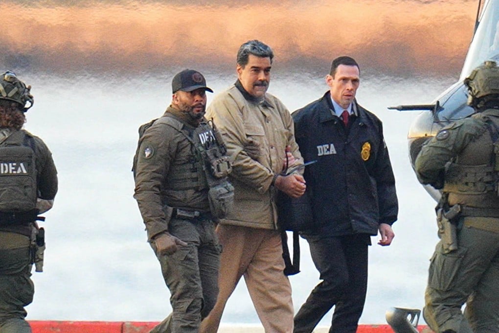 Nicolas Maduro in handcuffs after landing at a Manhattan helipad, escorted by heavily armed federal agents as he and his wife make their way into an armoured car en route to a federal courthouse. Photo: TNS