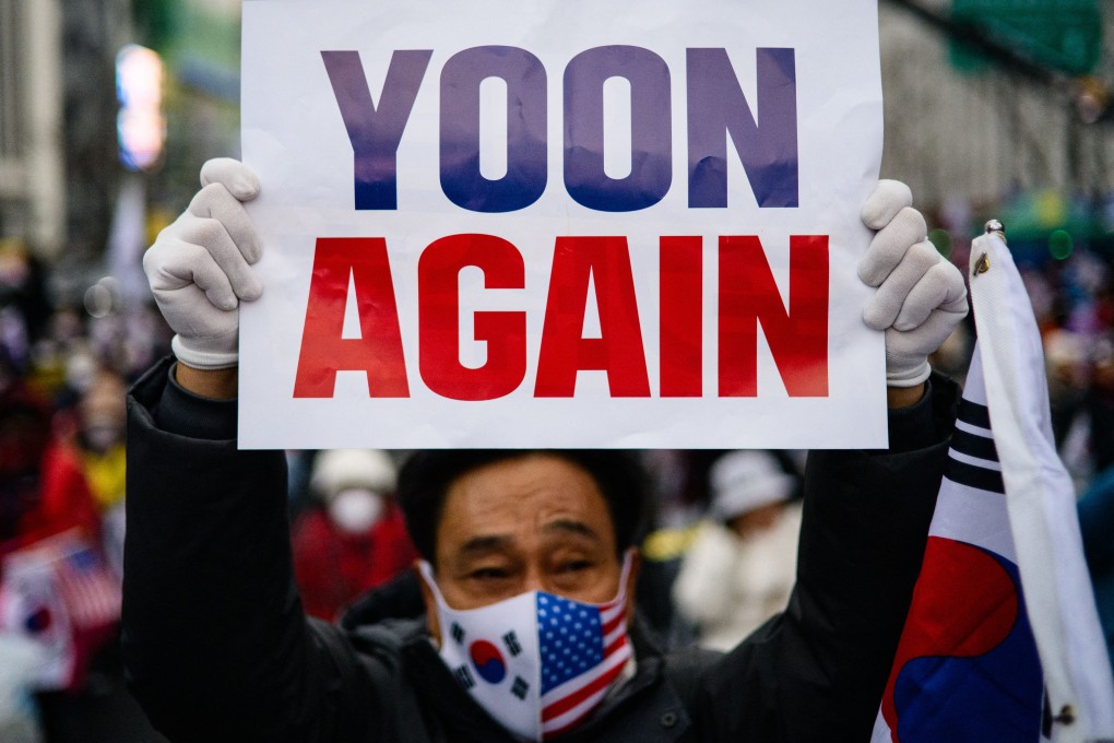 A supporter of South Korea’s ex-president Yoon Suk-yeol attends a rally in Seoul last month marking the first anniversary of his short-lived declaration of martial law. Photo: AFP