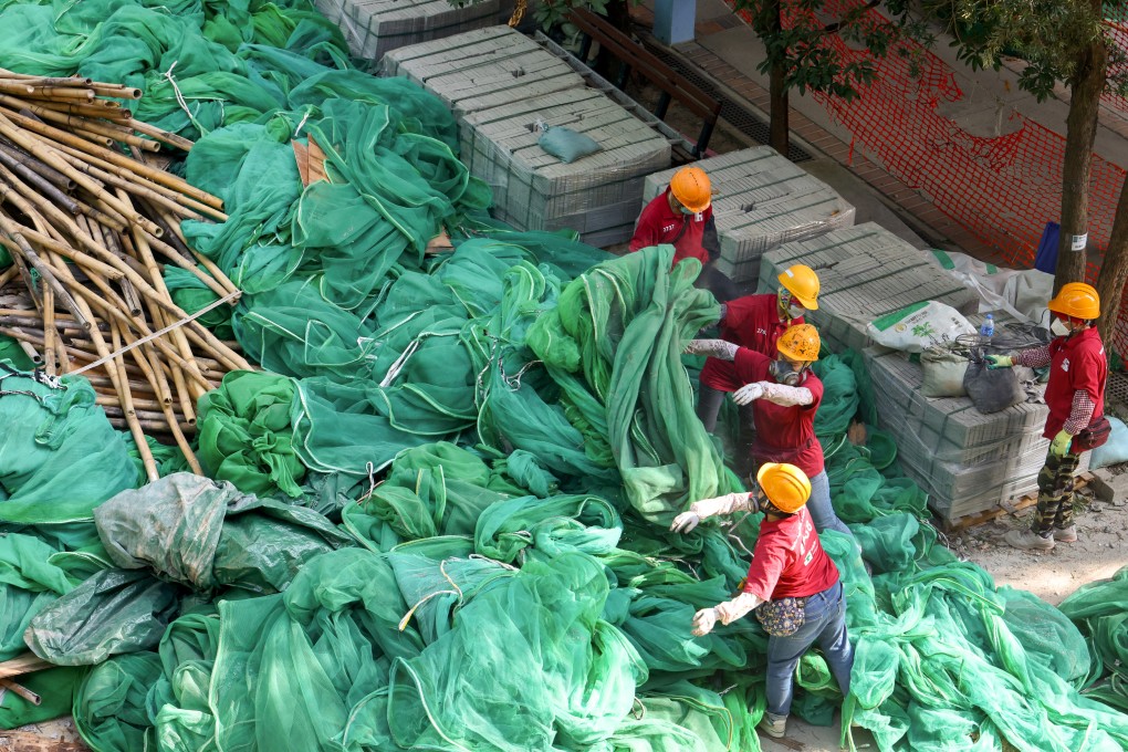Workers remove netting at a project in Fo Tan in December. Photo: Dickson Lee