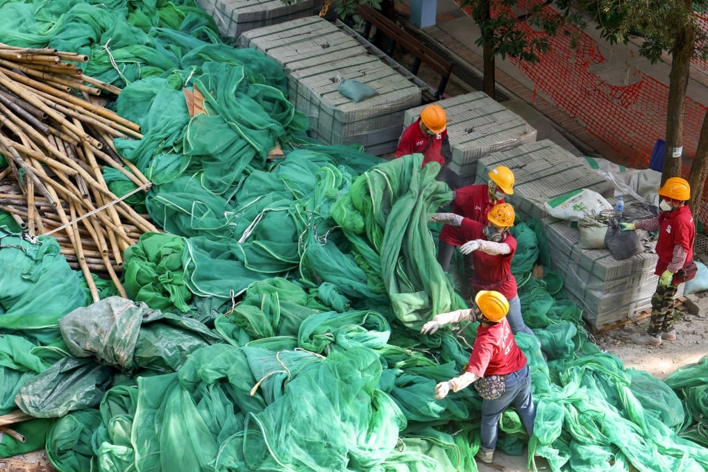 Workers remove netting at a project in Fo Tan in December. Photo: Dickson Lee