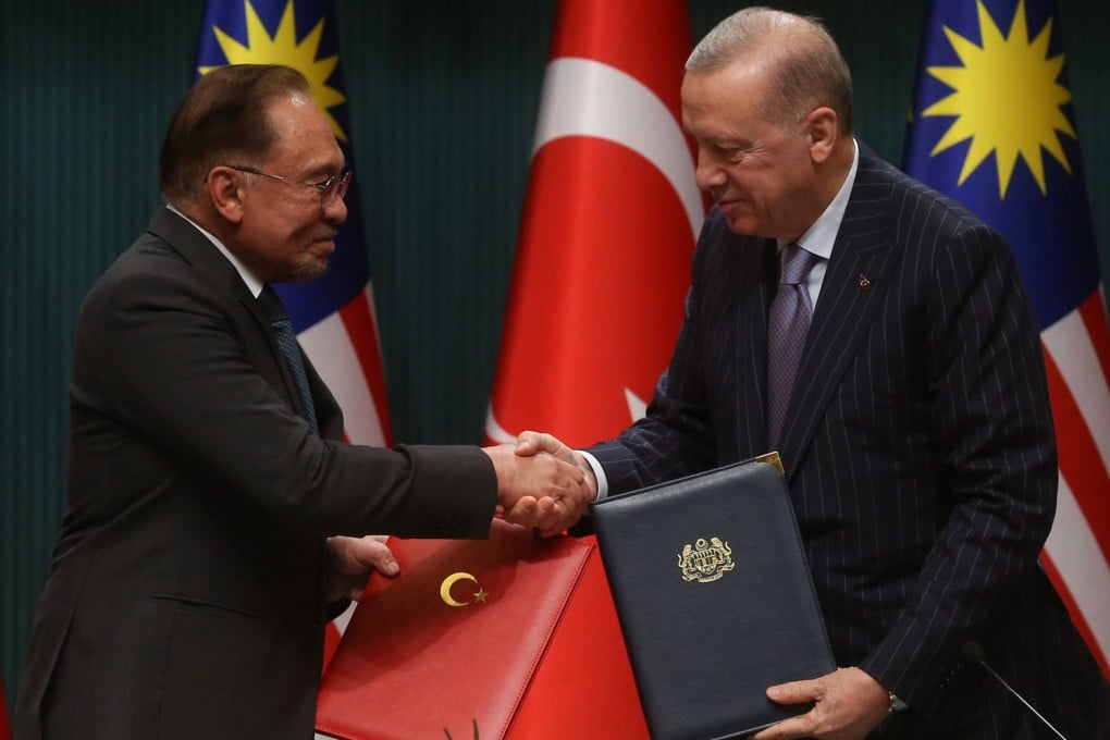 Turkish President Recep Tayyip Erdogan (right) and Malaysian Prime Minister Anwar Ibrahim exchange a signed agreement in Ankara on Wednesday. Photo: Turkish Presidency/Xinhua