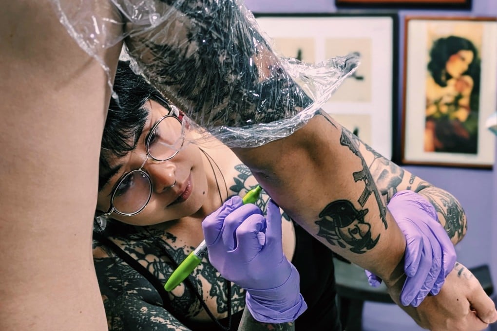 Bella Yuen tattoos a client at her Hong Kong studio. The artist, who is greatly influenced by Chinese calligraphy and painting, is one of a group in the city taking inspiration from traditional elements to create something new. Photo: Nic Tse