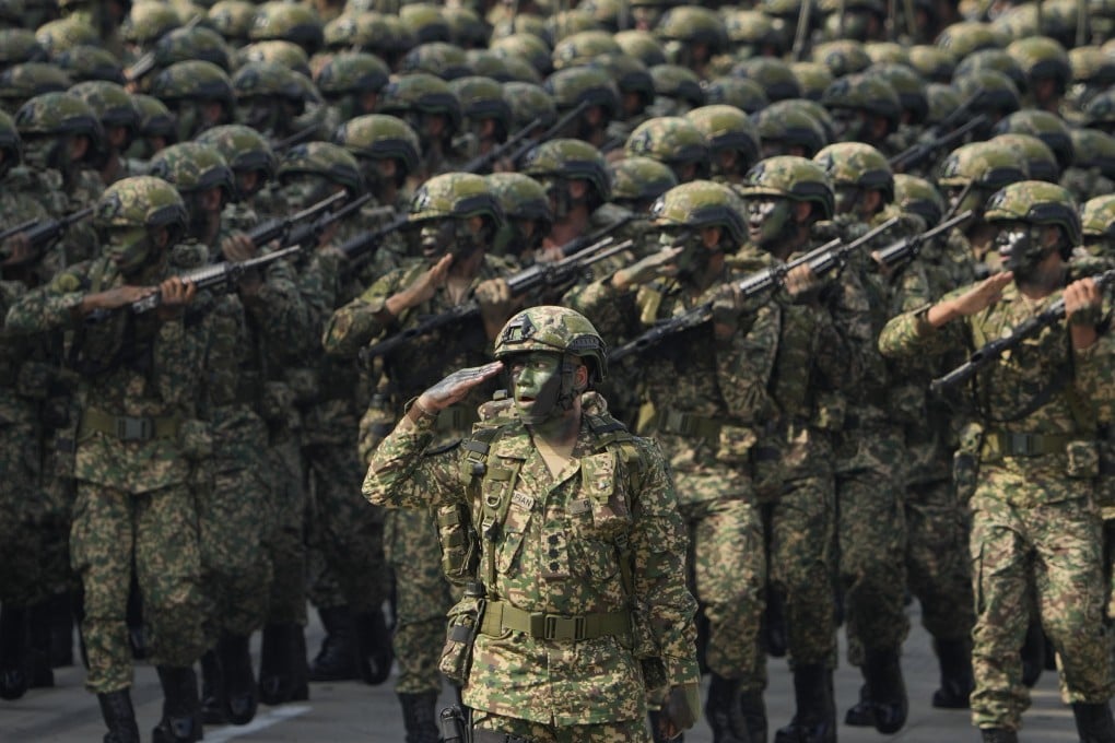Malaysian army troops march in formation for National Day celebrations. Photo: AP