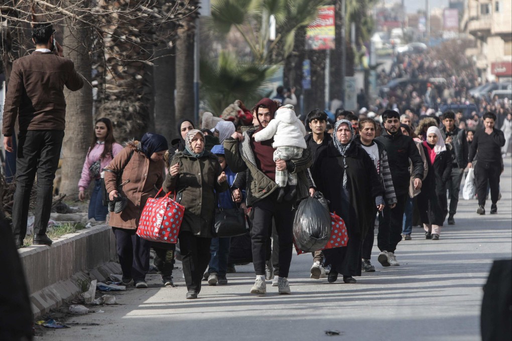 People flee Aleppo’s Ashrafiyah Kurdish neighbourhood on Wednesday. Photo: AFP