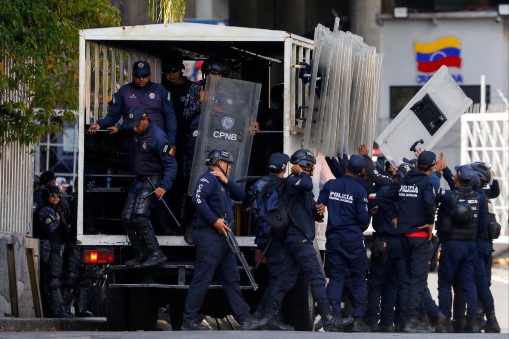 Bolivarian National Police unload riot control gear outside the Helicoide detention centre in Caracas before the release of foreign and Venezuelan prisoners. Photo: Reuters