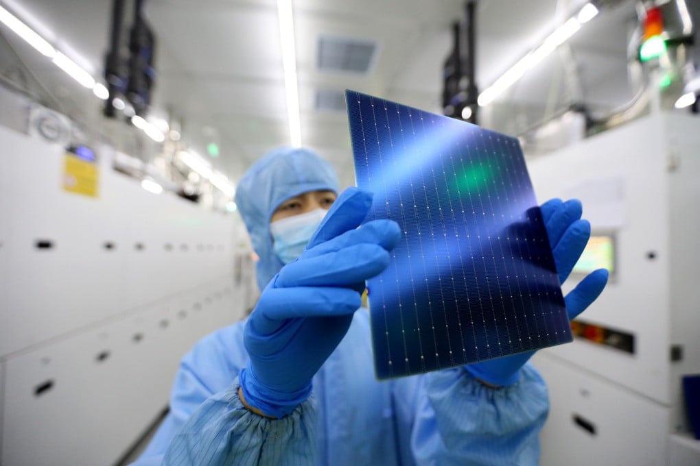 A worker examines a solar panel at a manufacturing facility in China’s Jiangsu province in September. Photo: Getty Images