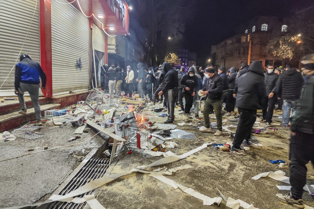 Iranians gather while blocking a street during a protest in Kermanshah, Iran, on Thursday. Photo: TNS