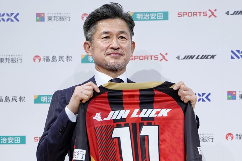 Kazuyoshi Miura poses with third division J-League team Fukushima United’s football top during a press conference. Photo: AP