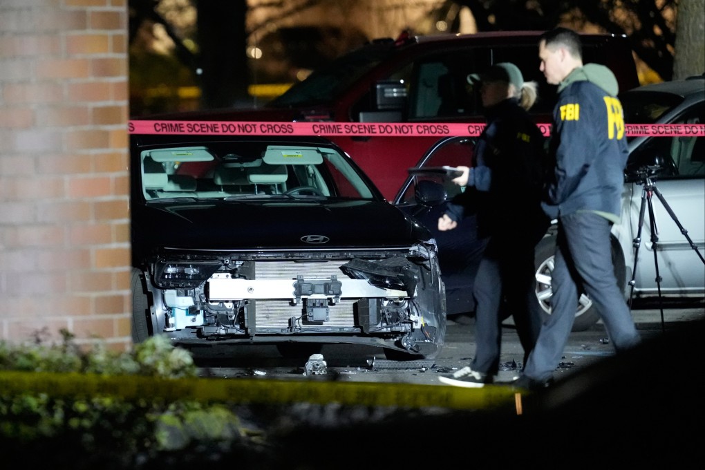 A damaged car and law enforcement officials at the scene of the shooting in Portland. Photo: AP