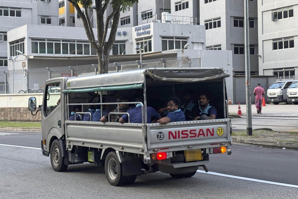 Migrant workers in the back of an open lorry in Singapore on December 6, 2025. Photo: Kyodo