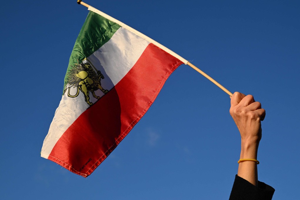A protester in Paris waves a pre-1979 Islamic Revolution Iranian flag during a demonstration on January 4. Photo: AFP