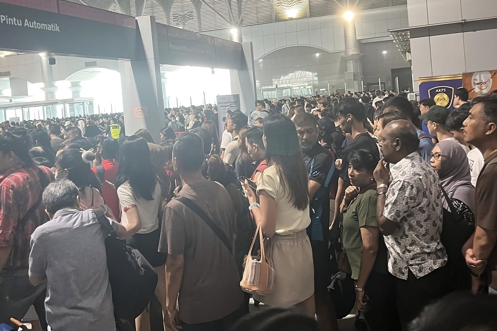 An image circulated on social media on Saturday shows a crowd of travellers waiting to pass through automated immigration gates at the Malaysia-Singapore border. Photo: Facebook