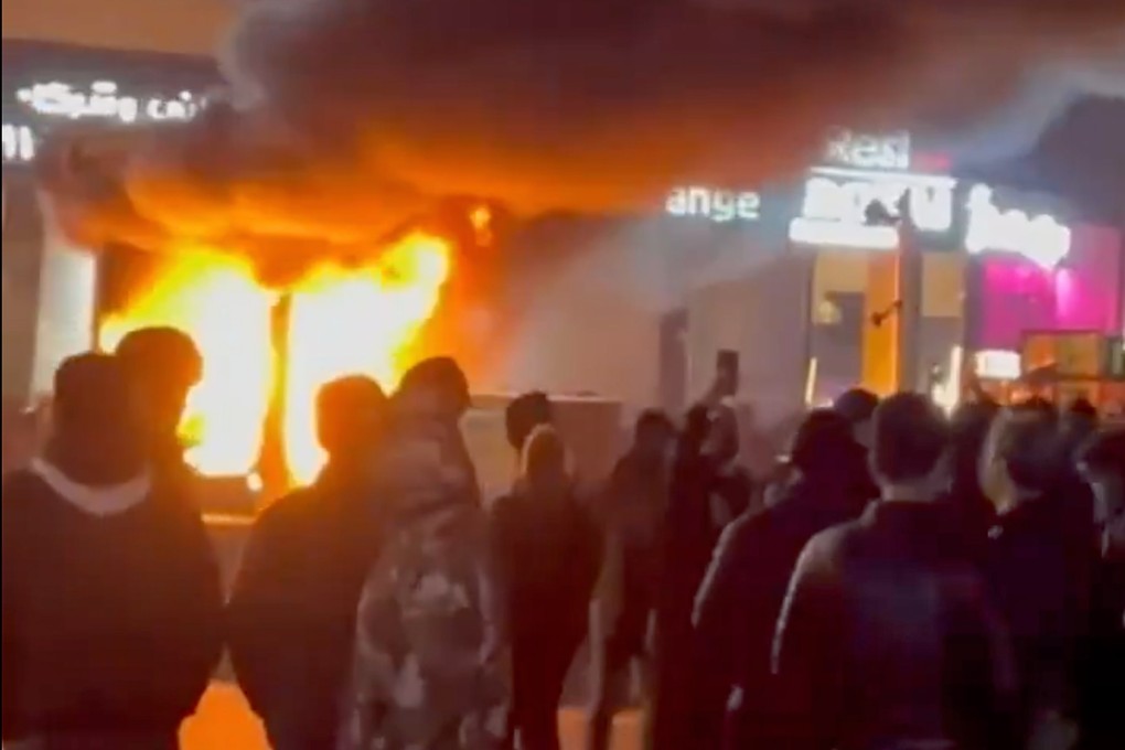 A frame grab from video shows a fire as people protest in Tehran, Iran, on Friday. Photo: UGC via AP