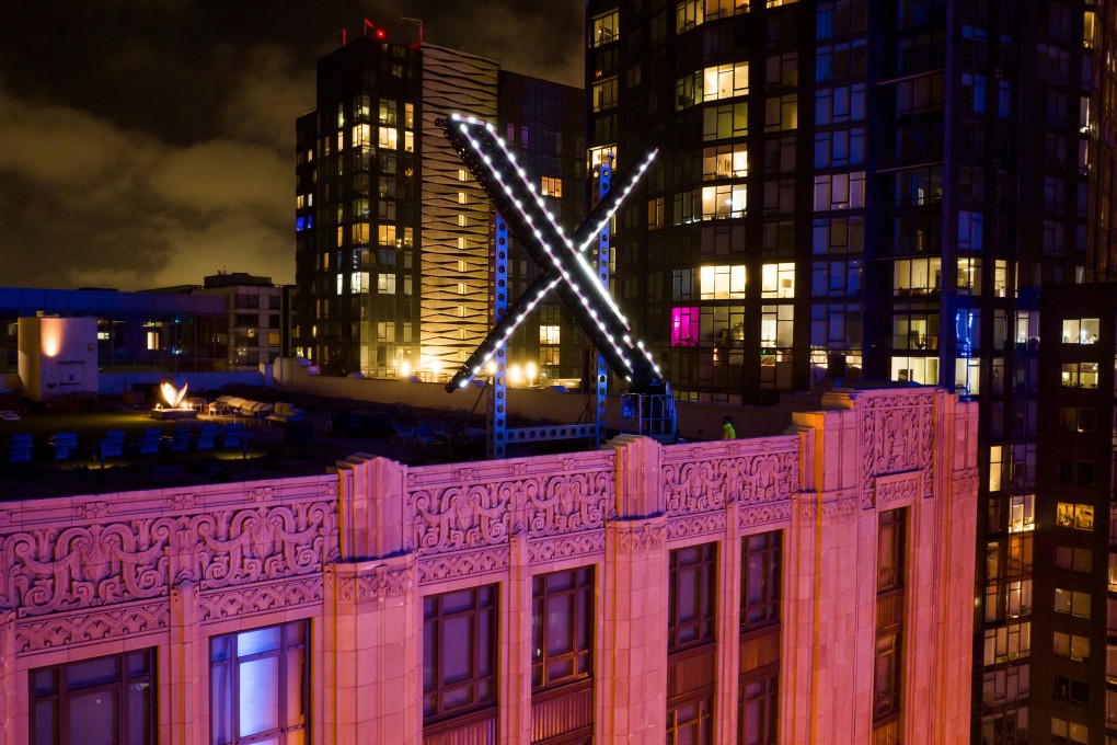 Workers install lighting on an ‘X’ sign atop the company headquarters, formerly known as Twitter, in downtown San Francisco in 2023. Photo: AP