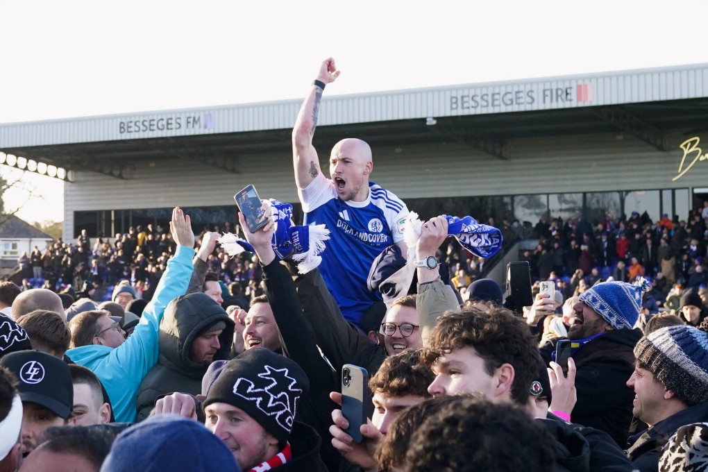 Macclesfield Town’s Josh Kay celebrates with fans after beating Crystal Palace. Photo: AP
