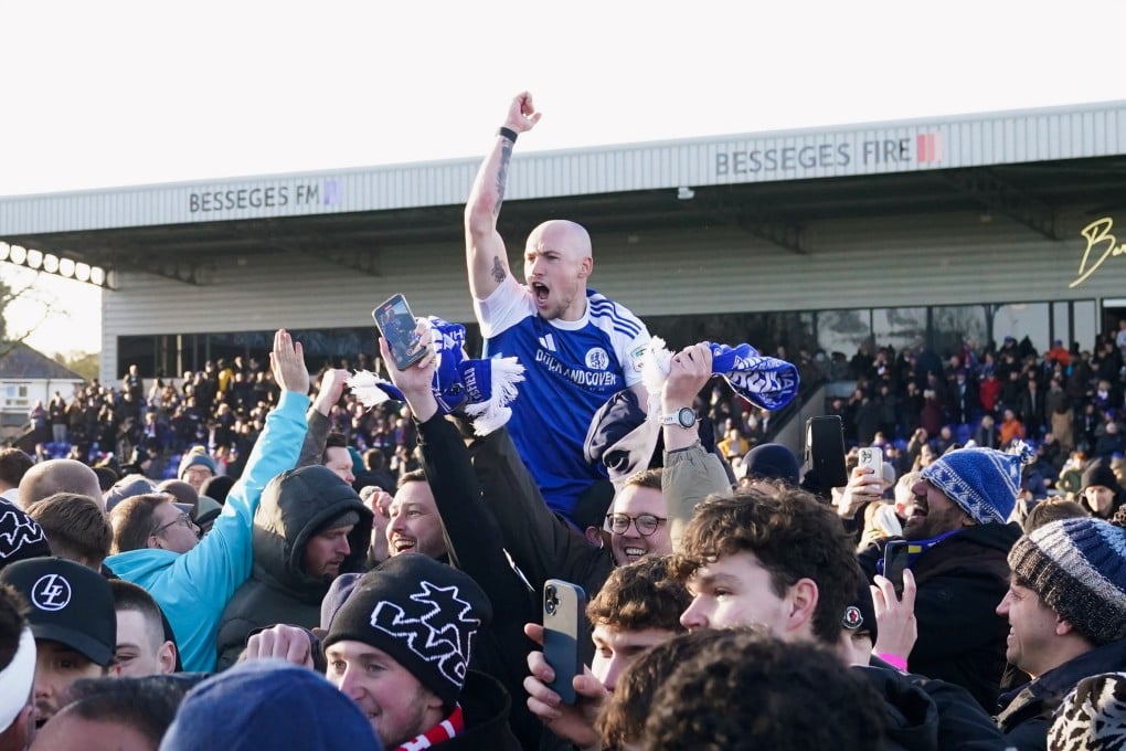 Macclesfield Town’s Josh Kay celebrates with fans after beating Crystal Palace. Photo: AP