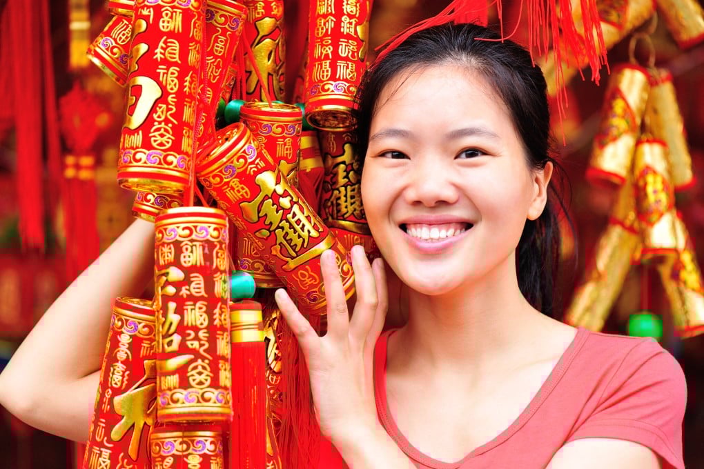 A woman holds Lunar New Year decorations. Throughout China, greetings in various dialects will be exchanged to welcome the Year of the Horse. Here are some of them and their meanings. Photo: Shutterstock