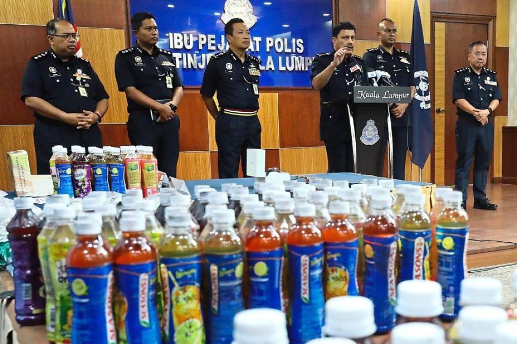 KL police display drug laced drinks seized in a 2023 raid. Photo: The Star