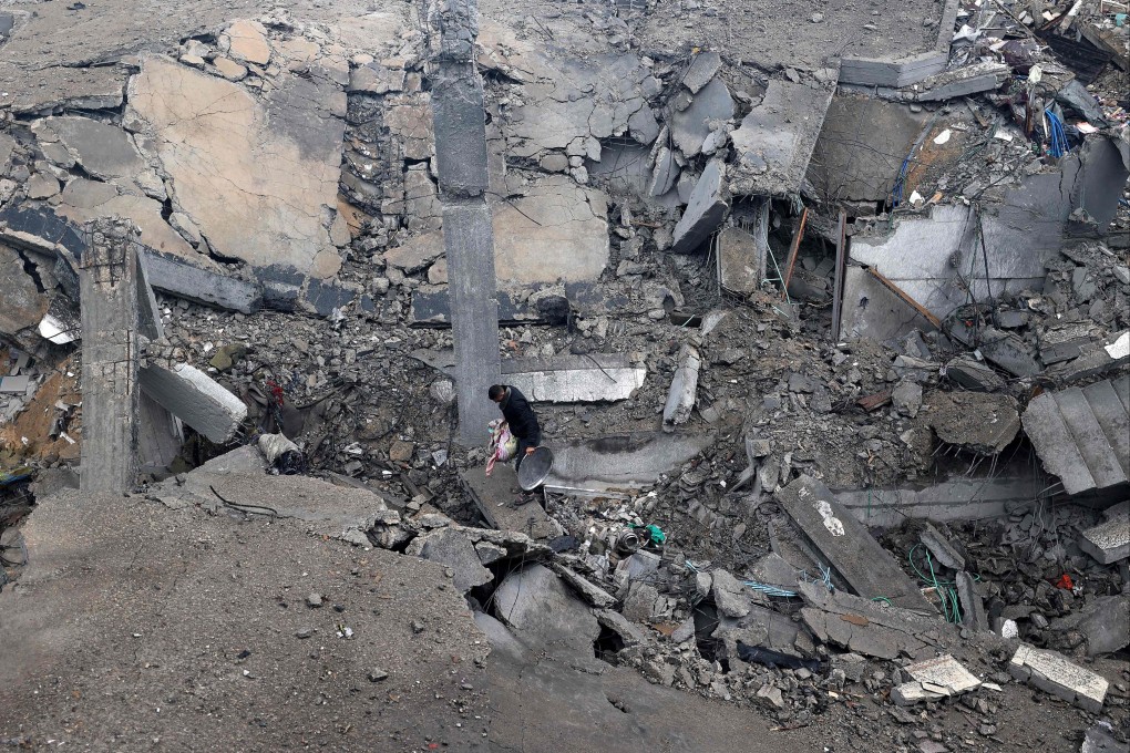 A man walks amid destruction in the Bureij camp in the central Gaza Strip. Photo: AFP