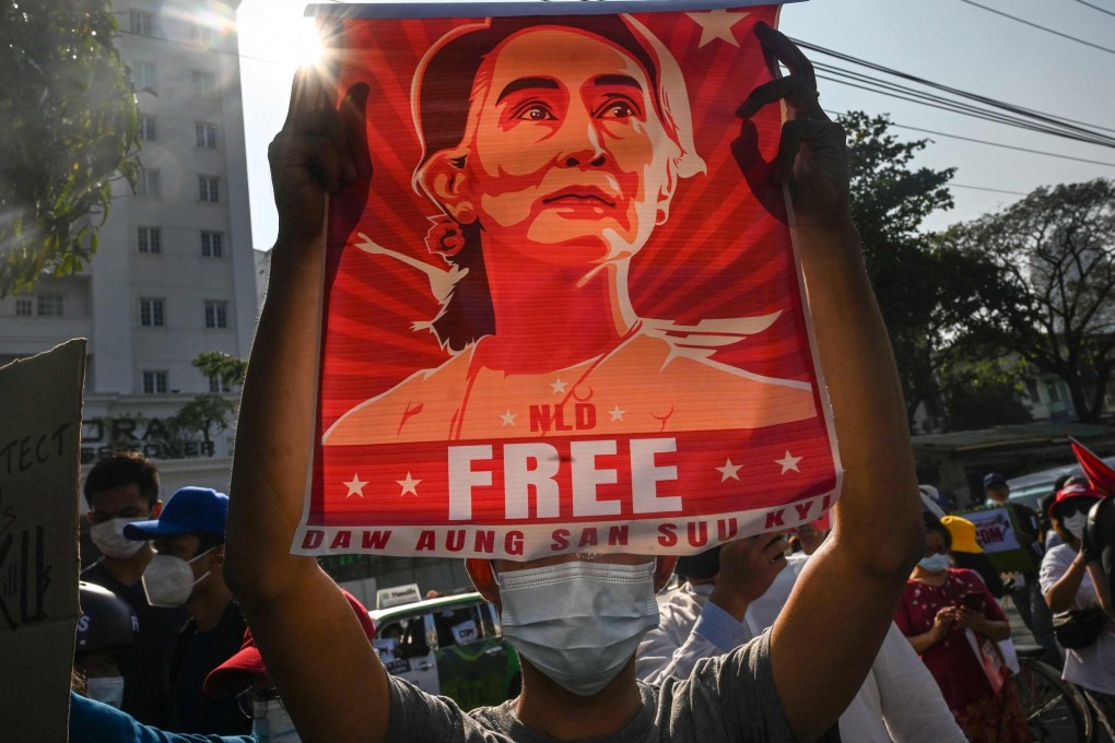 A protester holds up a poster featuring Aung San Suu Kyi during a demonstration against the military coup on February 15, 2021. Photo: AFP