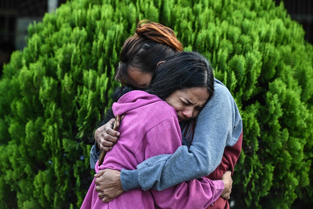 Relatives of inmates hug each other after visiting their loved one at El Rodeo 1 prison, outside Caracas in Venezuela. Photo: AFP