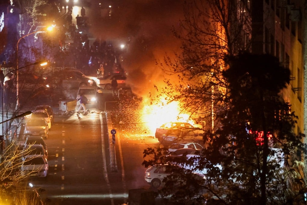 Cars burn in a street during a protest in Tehran on January 8. Photo: West Asia News Agency via Reuters