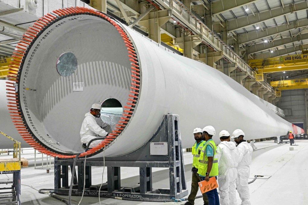 Employees work on a wind turbine blade at an Adani Group factory in Mundra, India. Photo: AFP