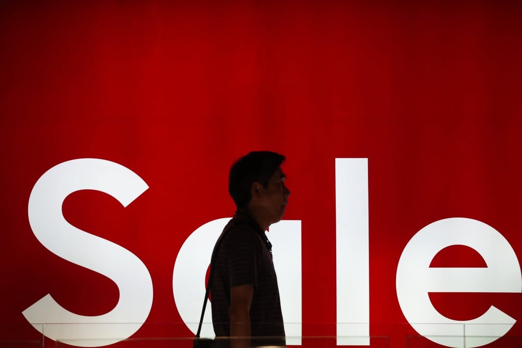 A shopper walks past a “Sale” sign at a shopping centre in Bangkok on January 2. Photo: EPA