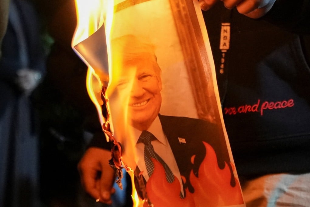 Iraqis burn an image of US President Donald Trump on Tuesday during a rally held in Basra in solidarity with Iran’s government. Photo: Reuters
