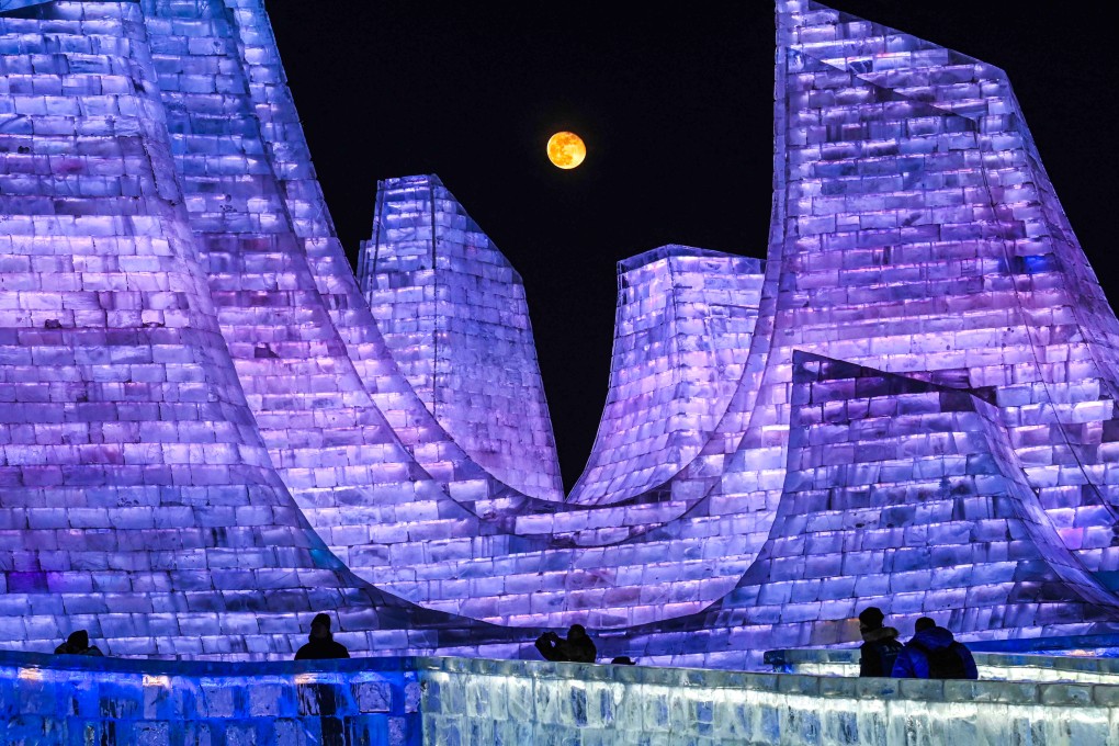 The moon rises above illuminated ice sculptures during the opening ceremony of the 42nd Harbin China International Ice and Snow Festival at Harbin in northeastern China’s Heilongjiang province on January 5. Photo: AFP