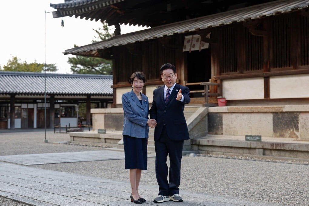 Japan’s Prime Minister Sanae Takaichi (left) and South Korea’s President Lee Jae Myung shake hands during a visit to Horyu-ji Temple in Ikaruga, Nara prefecture, on Wednesday. Photo: AFP