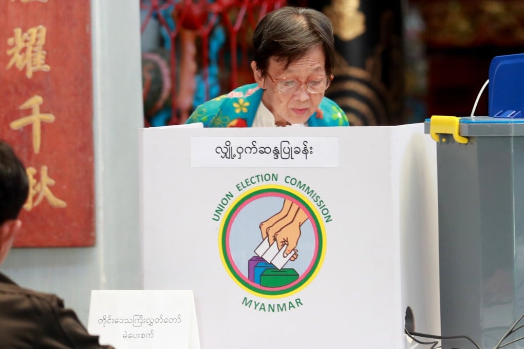 A woman casts a ballot during the second phase of Myanmar’s election in Yangon on Sunday. Photo: EPA
