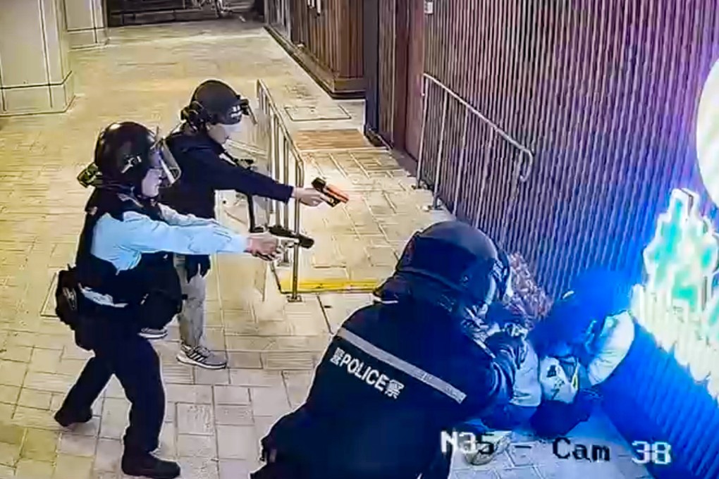 Police officers point their weapons at the man in Tuen Mun Town Plaza. Photo: Handout