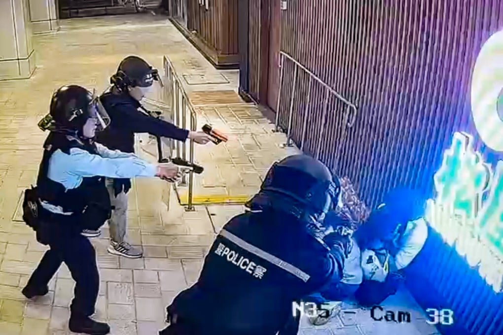 Police officers point their weapons at the man in Tuen Mun Town Plaza. Photo: Handout