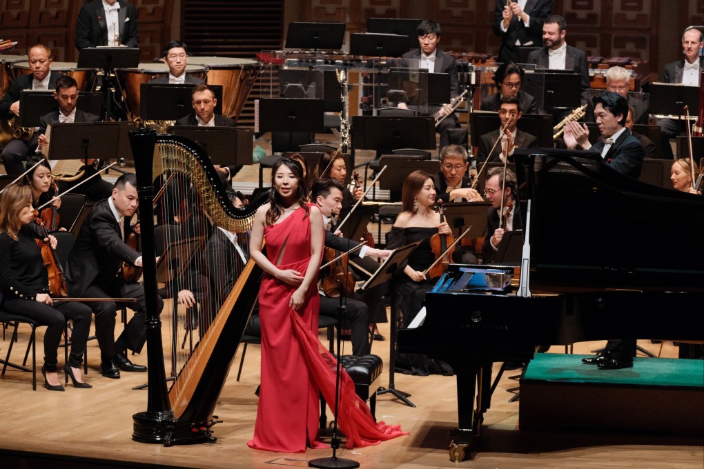 Lora Chow (in red) performs her piece “Awakening”, in which she plays piano and sings, with the Hong Kong Philharmonic Orchestra in 2024. Photo: Lora Chow