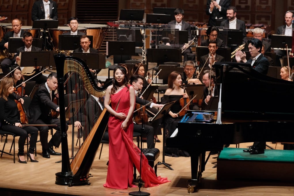 Lora Chow (in red) performs her piece “Awakening”, in which she plays piano and sings, with the Hong Kong Philharmonic Orchestra in 2024. Photo: Lora Chow