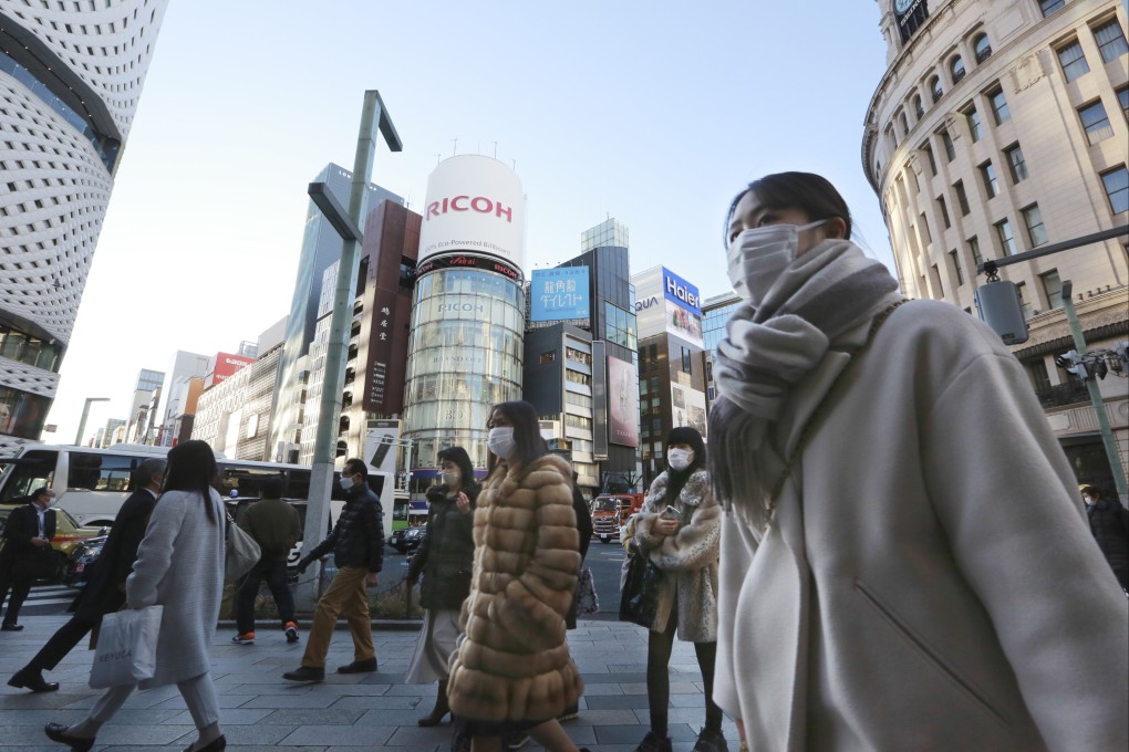 People wearing face masks walking on a street in Tokyo. Japan imports most of its antibiotics from China. Photo: AP
