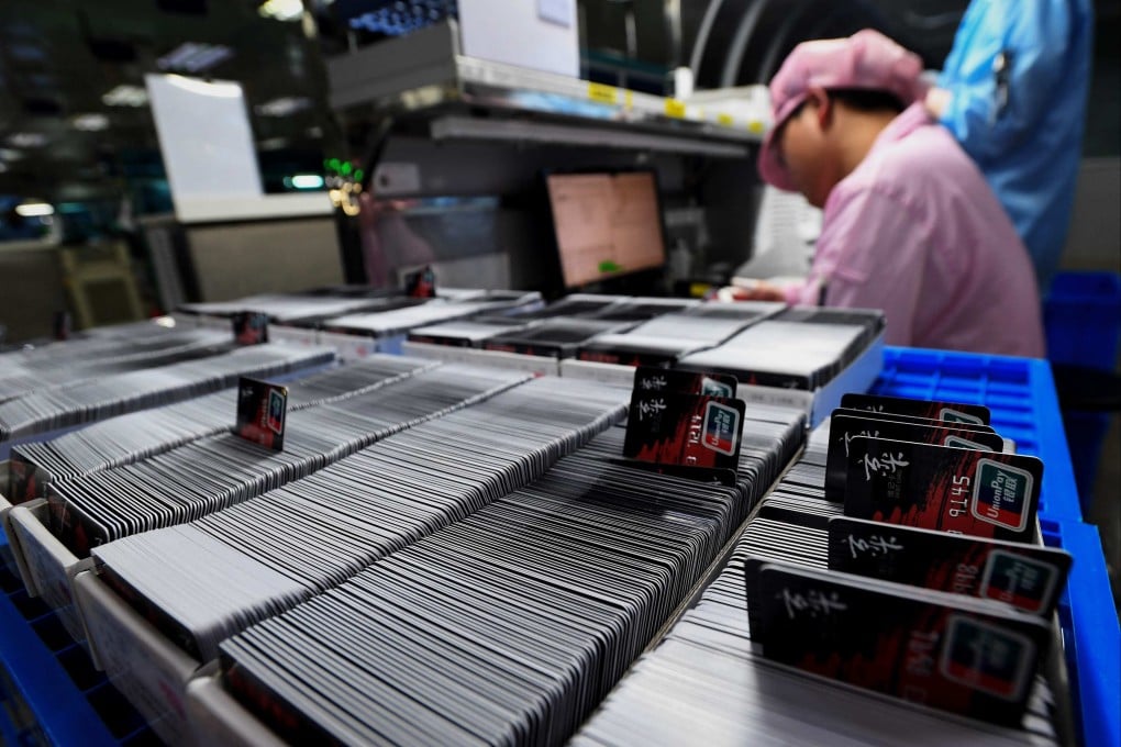 Workers produce bank cards at a factory in Wuhan, Hubei province, in April 2024. Photo: AFP