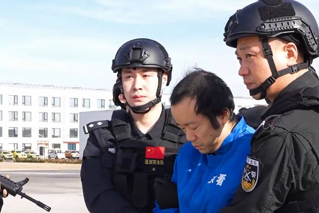 This frame grab taken from undated handout video footage released by China’s Ministry of Public Security shows guards escorting handcuffed accused scam boss Chen Zhi, centre, off a plane in Beijing. Photo: AFP/Ministry of Public Security handout