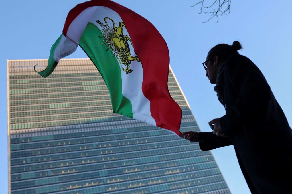 A protester waves the Iranian flag outside UN headquarters in New York during a Security Council meeting on Iran on Thursday. Photo: AFP
