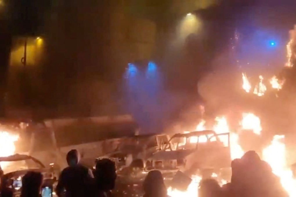 Protesters gather as vehicles burn, amid anti-government protests in Tehran, Iran, in this screen grab from a social media video released on January 9. Photo: Social media via Reuters