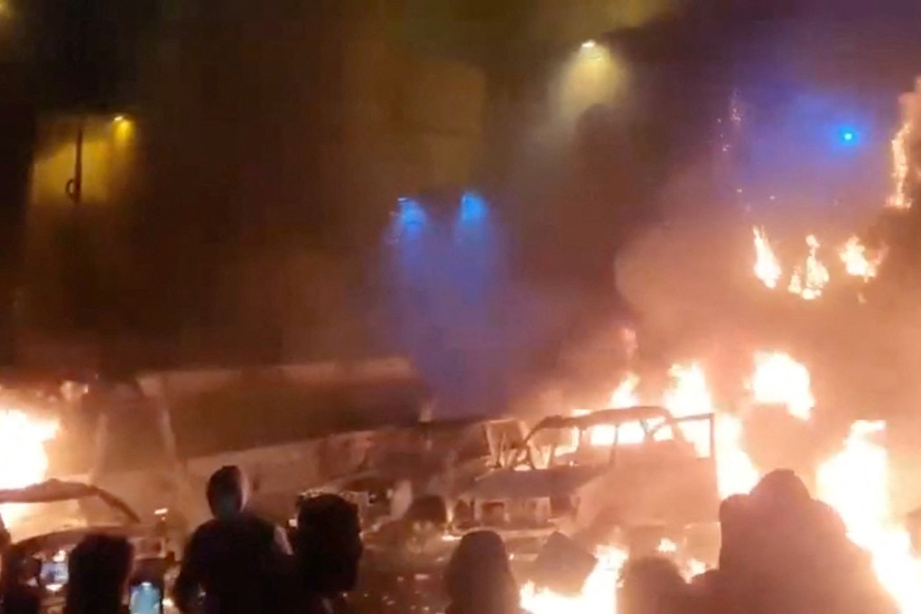 Protesters gather as vehicles burn, amid anti-government protests in Tehran, Iran, in this screen grab from a social media video released on January 9. Photo: Social media via Reuters