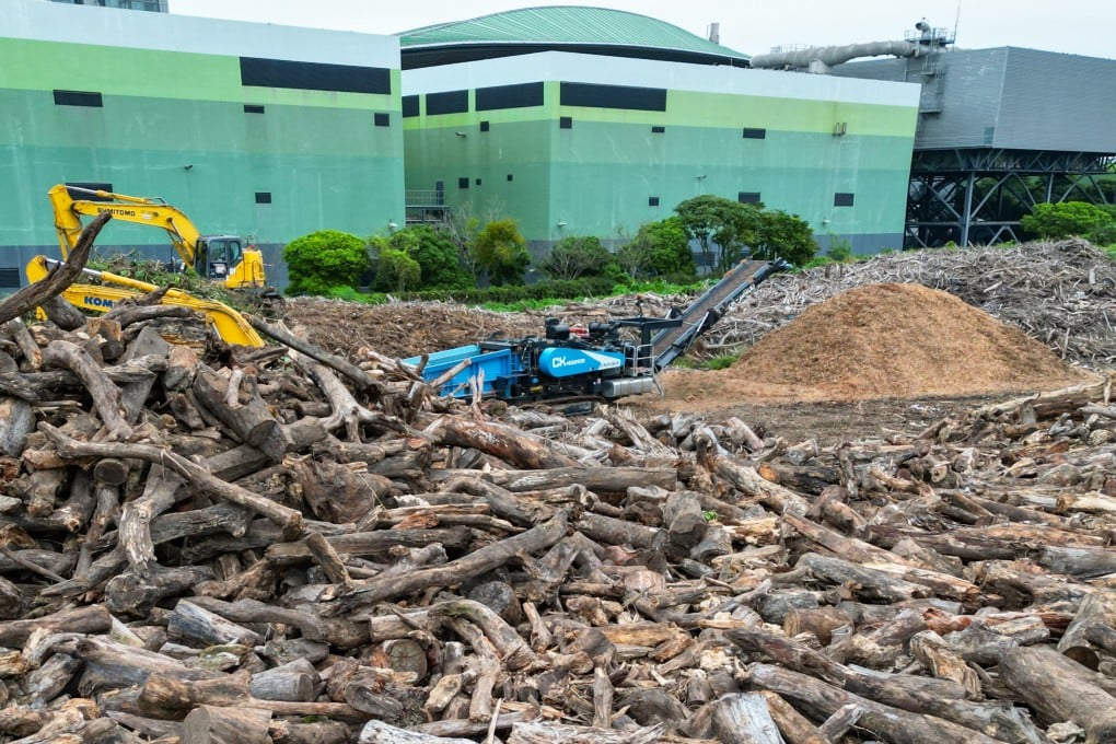 A wood chipping machine amid piles of tree trunks at Y·Park yard waste recycling plant in Tuen Mun. Photo: Dickson Lee